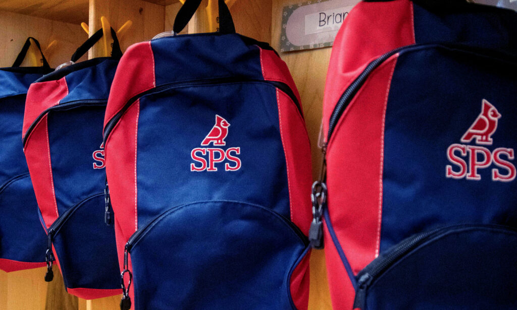 St. Peter's School navy and red backpacks with cardinal logos