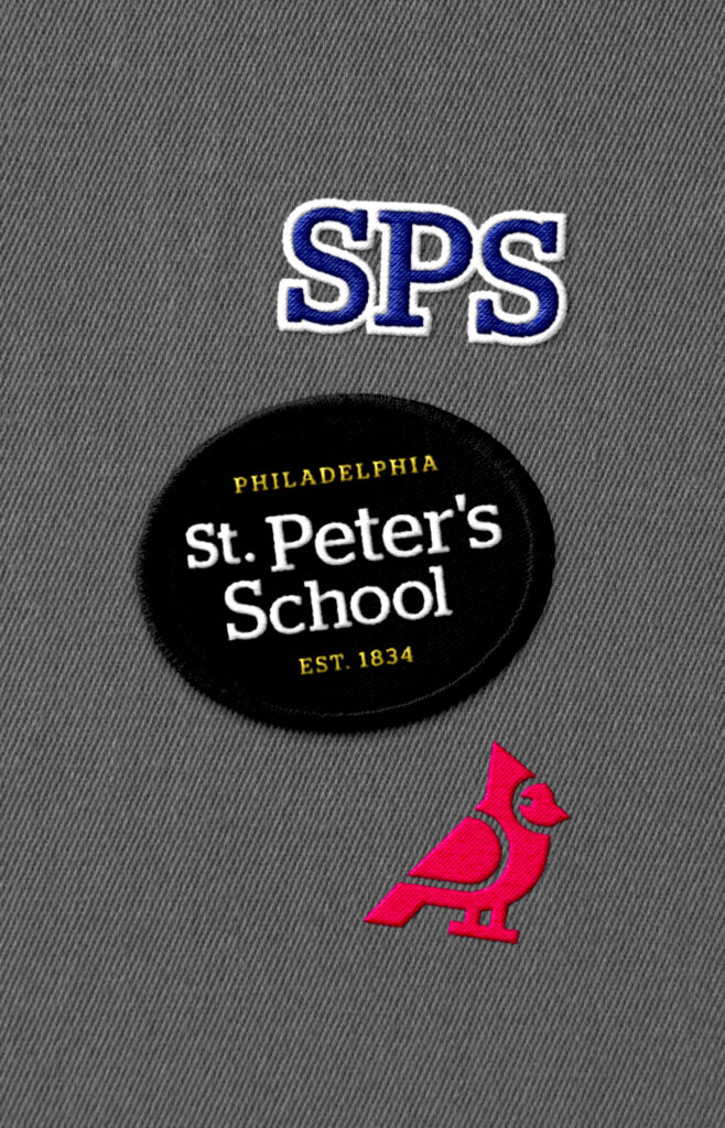 St. Peter's embroidered logo and cardinal patches on grey fabric